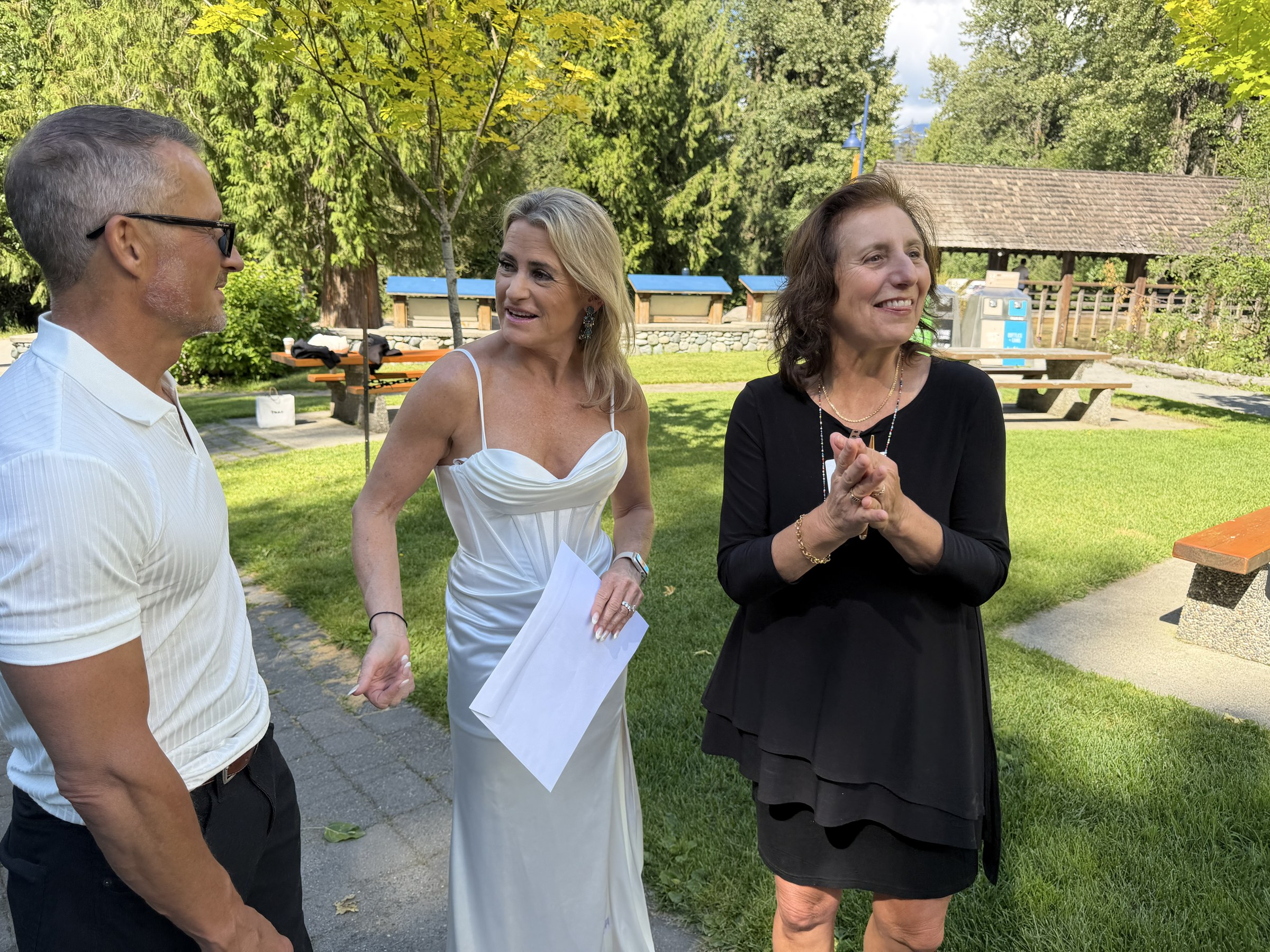 Deb and Daryl smiling with their officiant