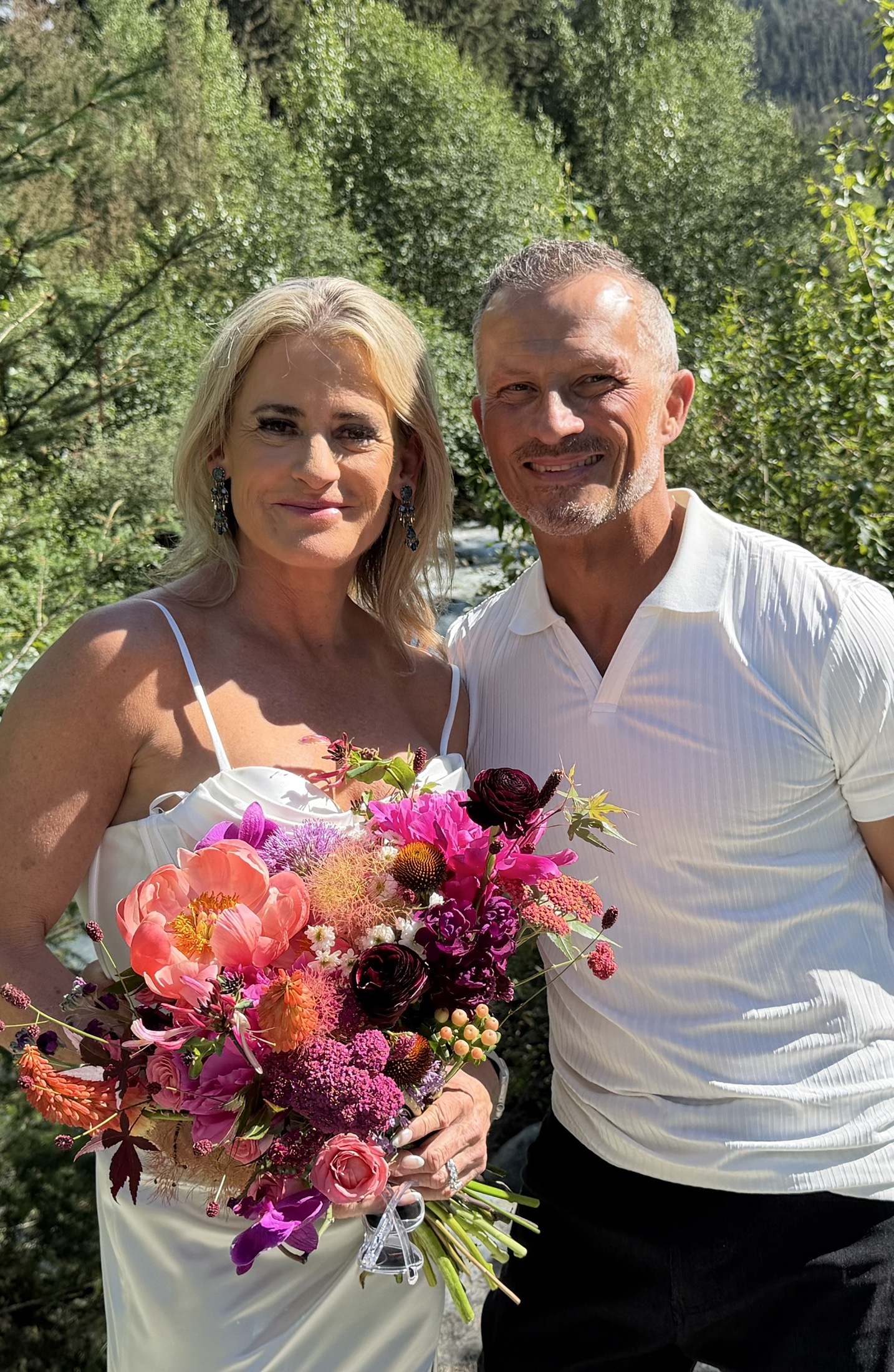 Deb and Daryl smiling together beside the river