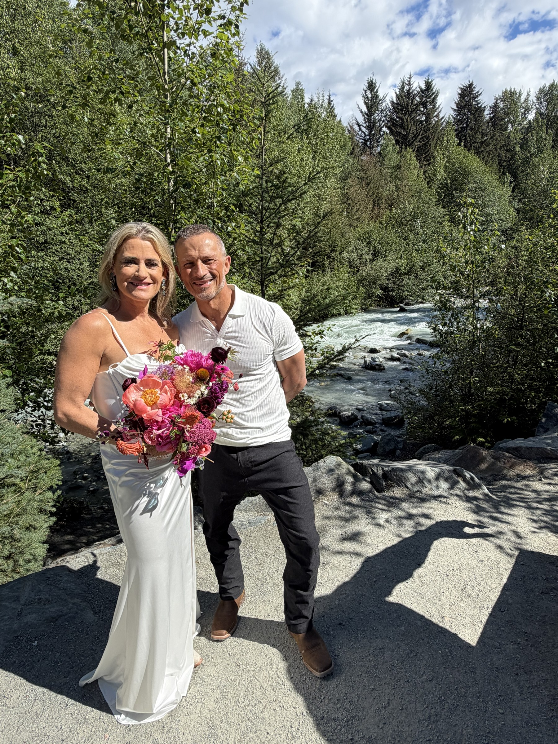 Deb and Daryl standing beside the mountain river